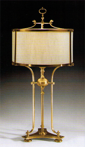 Antiqued brass three leg lamp with hardback lampshade